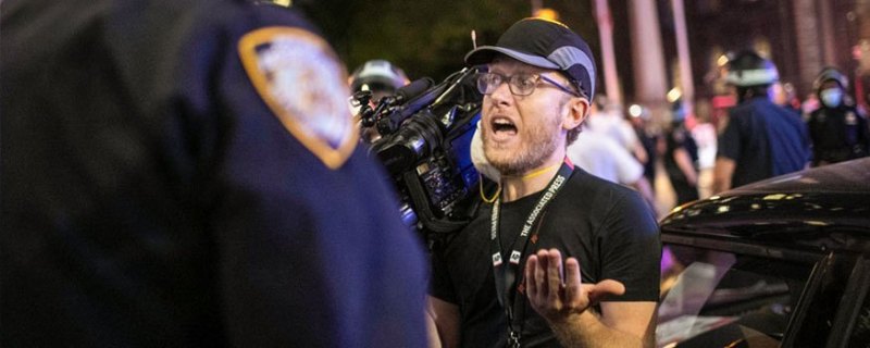 Journalist talking to police officer