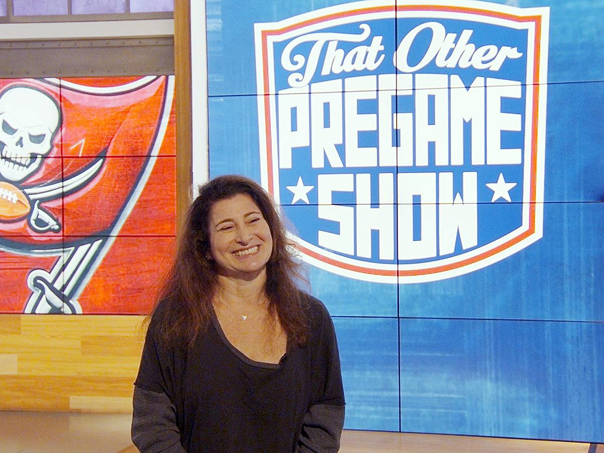 Penn State alumna Deb Gelman smiles while standing on the set of "That Other Pregame Show," which she produces every Sunday during the NFL season. Credit: Scott Myrick. All Rights Reserved.